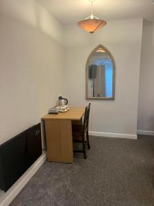 a dining room with a table and a mirror at Y Teifi in Llandysul
