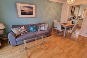 a living room with a couch and a table at Cosy Family Home Near the Quay in Exeter
