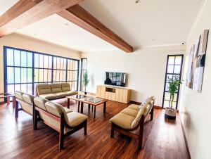 a living room with a couch and a table at Cottonwood Exclusive Villa @Lembang Asri - Jacuzzi Playground Netflix Billyard in Lembang