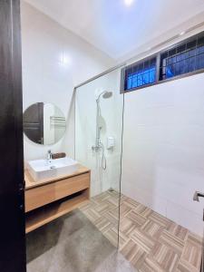 a bathroom with a sink and a shower at Cottonwood Exclusive Villa @Lembang Asri - Jacuzzi Playground Netflix Billyard in Lembang