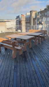 a picnic table and benches on top of a roof at Cozy 1 bedroom apartment in Oslo centrum in Oslo