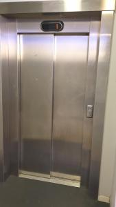 a large metal elevator in a building at Cozy 1 bedroom apartment in Oslo centrum in Oslo