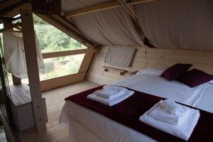 a bedroom with a bed with towels on it at Podere Prataccio in Grosseto