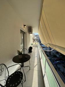 a balcony with a table and chairs on a building at Modern apartment in the heart of Athens. in Athens