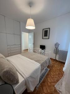 a bedroom with two beds and a lamp in it at Modern apartment in the heart of Athens. in Athens