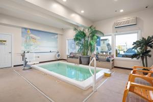a swimming pool in a living room with a pool at Beach Bum Inn in Ocean City