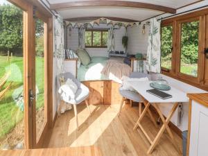 a bedroom in a tiny house with a bed at Fern in Bude
