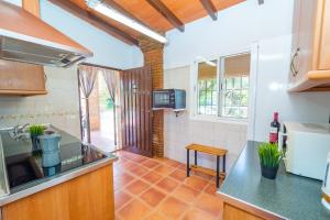 a kitchen with a sink and a counter top at Cubo's Finca Los Acebuches in Alhaurín el Grande