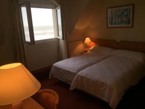 Кровать или кровати в номере Hotel La Terrasse