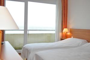 Кровать или кровати в номере Hotel La Terrasse