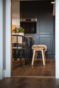 a kitchen with a table and a chair and a microwave at Drumdry in Wick