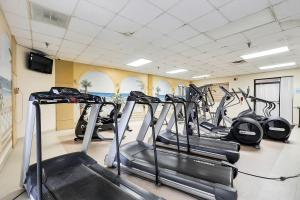 a gym with several tread machines in a room at Sea Watch Condos IX in Ocean City