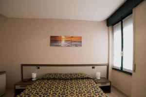 a bedroom with a bed and two nightstands and a window at Locanda San Fiorenzo in Fiorenzuola dʼArda