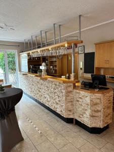 a bar in a restaurant with a counter at Hotel Rosengarten in Bernkastel-Kues