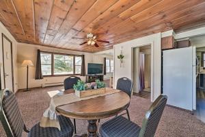 a dining room with a wooden ceiling and a table and chairs at Cozy Tawas City Home with Views of Lake Huron! in Tawas City