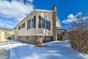 a house with snow in front of it at Cozy Tawas City Home with Views of Lake Huron! in Tawas City