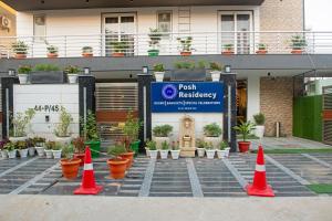 a group of orange cones in front of a building at Posh Residency Artemis Hospital Road Gurgaon in Gurgaon