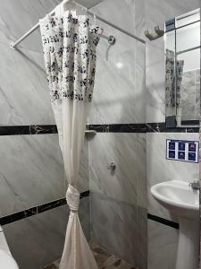 a shower curtain in a bathroom with a sink at Apartamentos Freddy's Tours in Santa Marta +64 photos