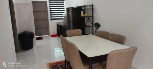 a dining room with a white table and chairs at Rayyan Homestay Seri Iskandar Perak Near Utp Uitm in Kampong Bota Road