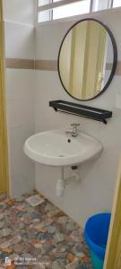 a bathroom with a white sink and a mirror at Rayyan Homestay Seri Iskandar Perak Near Utp Uitm in Kampong Bota Road