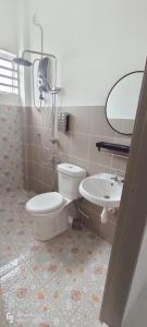 a bathroom with a toilet and a sink at Rayyan Homestay Seri Iskandar Perak Near Utp Uitm in Kampong Bota Road