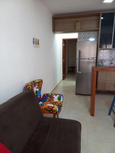 a living room with a couch and a kitchen at Lindo Apartamento em Lençóis in Lençóis