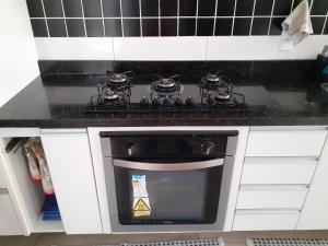 a stove top oven in a kitchen with white cabinets at Casa em Botafogo (Rio de Janeiro) in Rio de Janeiro