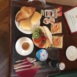 a tray of food with bread and a cup of coffee at Relais Vimercati in Crema