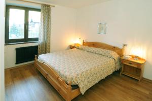 a bedroom with a bed and a table and a window at Casa Molini in Malè