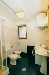 a bathroom with two toilets and a sink at Casa Molini in Malè