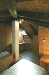 an attic room with two beds and a desk at Casa Molini in Malè