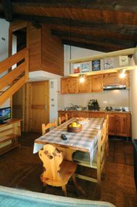a kitchen with a large wooden table and a dining room at Casa Molini in Malè