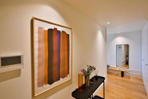 a living room with a painting on the wall at 4CITY FLAT CAMARÃO in Porto