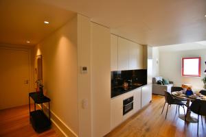 a living room with a kitchen and a dining room at 4CITY FLAT CAMARÃO in Porto +13 photos