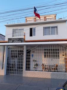 a building with a flag on top of it at Hostal D' Silvia in Arica