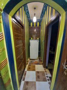 a kitchen with a colorful hallway with a refrigerator at Sabrina home in Aswan +13 photos