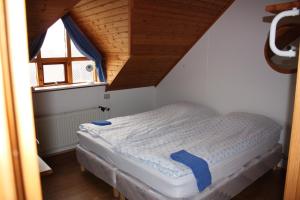een klein bed in een kamer met een raam bij Skútustadir Guesthouse in Myvatn