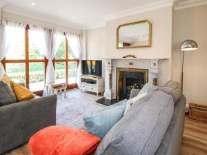 a living room with a couch and a fireplace at Avenue Croft in Nottingham