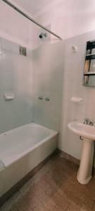 a bathroom with a bath tub and a sink at Hotel Central in Buenos Aires