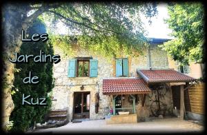 a stone house with a sign that reads les jardins de kru at Ours-Les Jardins de Kuz in Bernin