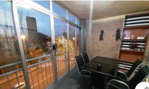 a room with a table and chairs and a large window at Angel in Zamora