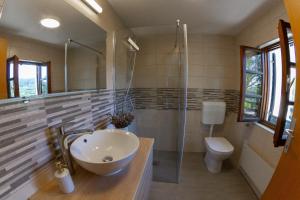 a bathroom with a sink and a toilet at Andy's Holiday Home with HotTub & Sauna 