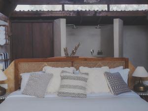a bedroom with a bed with white pillows at Vaayu Kula mandrem in Mandrem