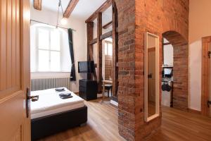 a room with a brick wall and a room with a bed at Ferienwohnung Venus in Quedlinburg