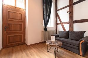 a living room with a couch and a table at Ferienwohnung Venus in Quedlinburg +12 photos