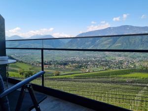 a balcony with a view of a valley and mountains at Hotel Appartements Graf Hartwig in Schenna