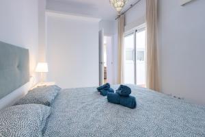 a bedroom with a bed with blue towels on it at Charming 2 Bedroom Apartment Triana Bridge By OCityzen in Seville +12 photos
