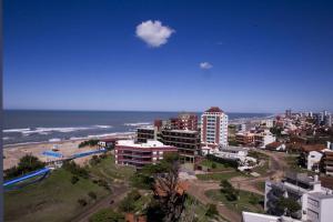 a city with a beach and buildings and the ocean at IEMANJA Depto Villa Gesell in Villa Gesell