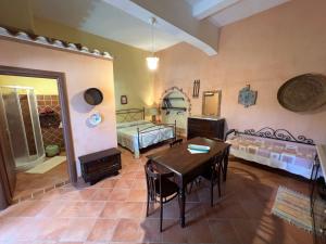 a living room with a table and a bed at B&B Rita and Family in Loceri