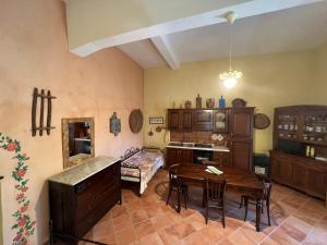 a kitchen with a table and a dining room at B&B Rita and Family in Loceri